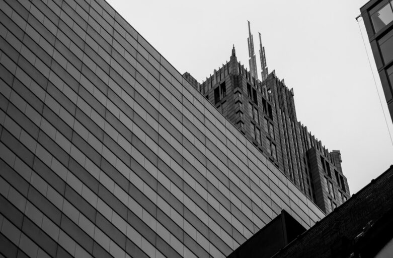Classic, ornate building stands next to a sleek, modern glass skyscraper, symbolizing the evolution from traditional SEO t...