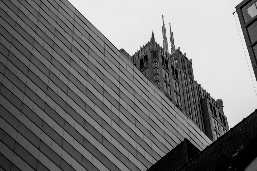Classic, ornate building stands next to a sleek, modern glass skyscraper, symbolizing the evolution from traditional SEO t...