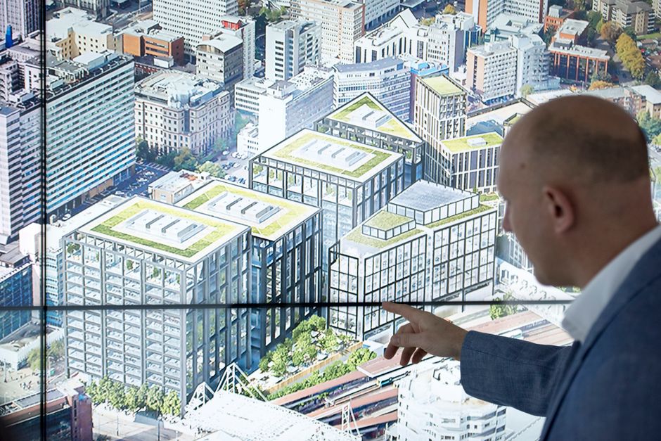 Marketing professional's hands interacting with a futuristic, glowing digital map on a large touchscreen, symbolizing AI-p...