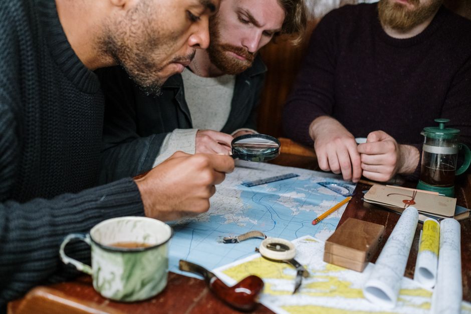 A bright, professional photo of a magnifying glass held over a map, focusing on a specific location to represent a niche content marketing strategy.