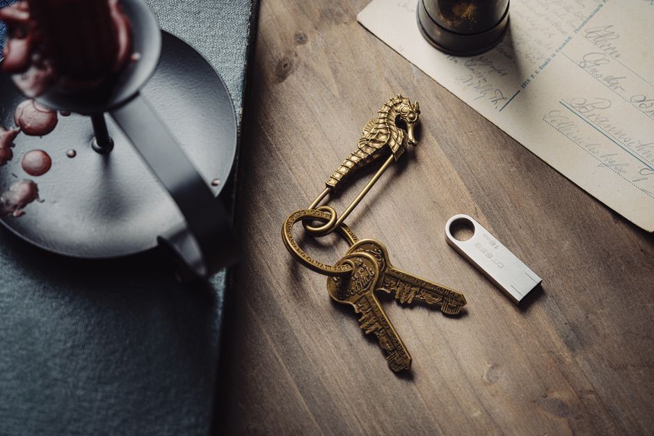 A single, ornate antique key lying on a clean, modern desk, symbolizing the unique solution of a niche strategy to unlock SEO success.